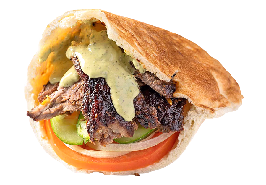 Sultan's Market Lamb Shawarma Sandwich: Marinated spit roasted lamb and beef thinly sliced lamb, served in a pita with hummus, onions, cucumbers, tomatoes and tahini sauce.